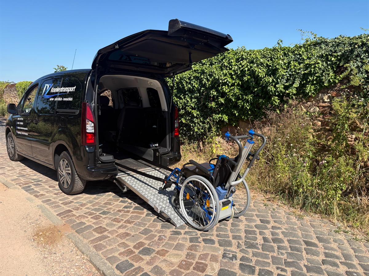 Fahrzeug von DZ Krankentransport mit ausgeklappter Rollstuhlrampe am Heck